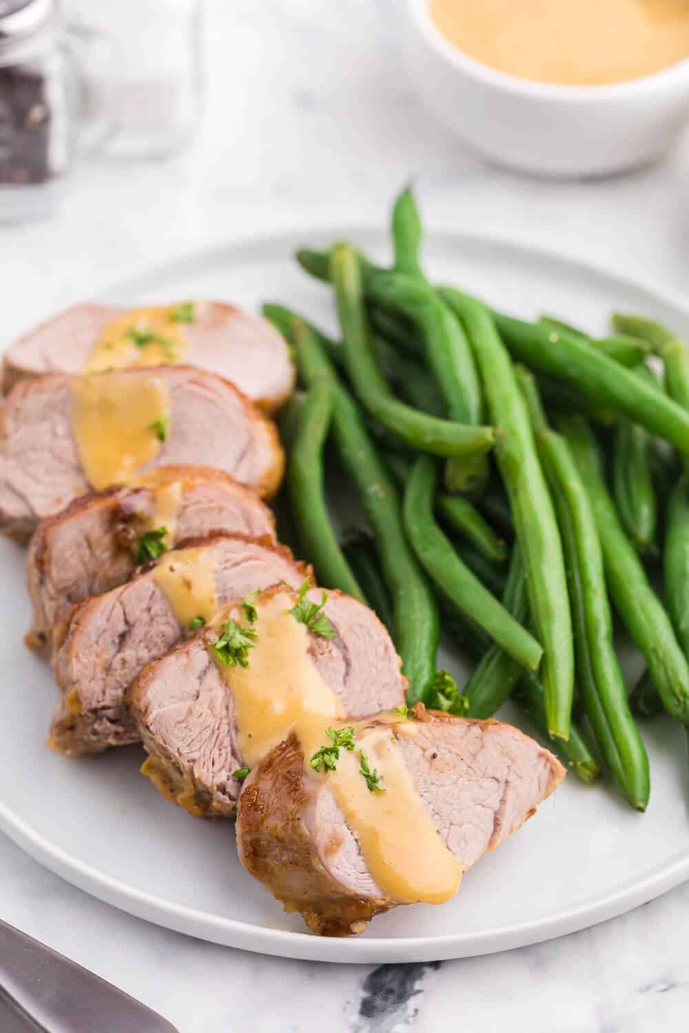 Brown Sugar Dijon Pork Tenderloin - Only two ingredients for this delicious dinner recipe! This sweet and savory glaze goes perfectly with the tender, juicy pork.