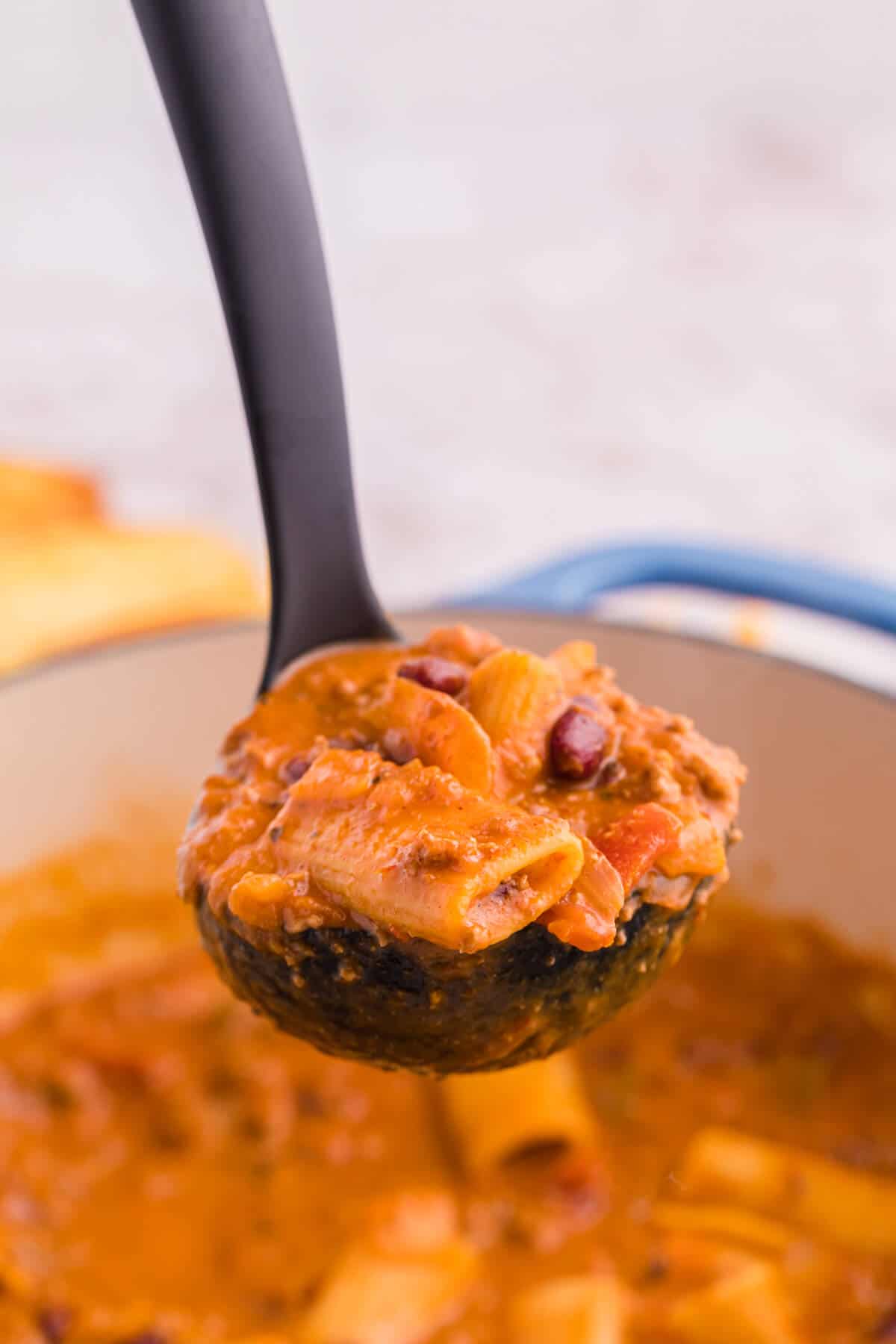 Chili rigatoni in a ladle.