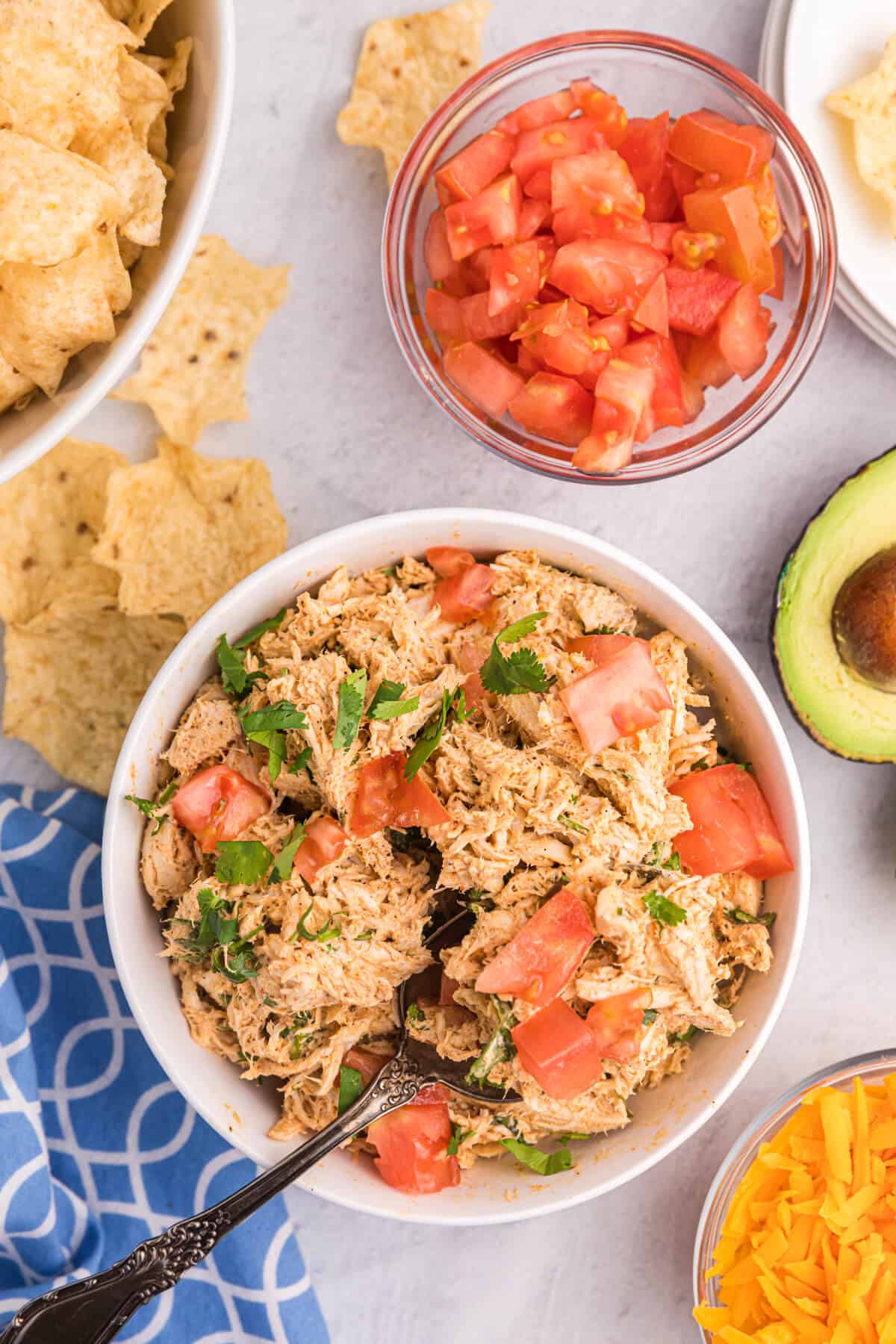 Taco chicken salad in a bowl with a fork.