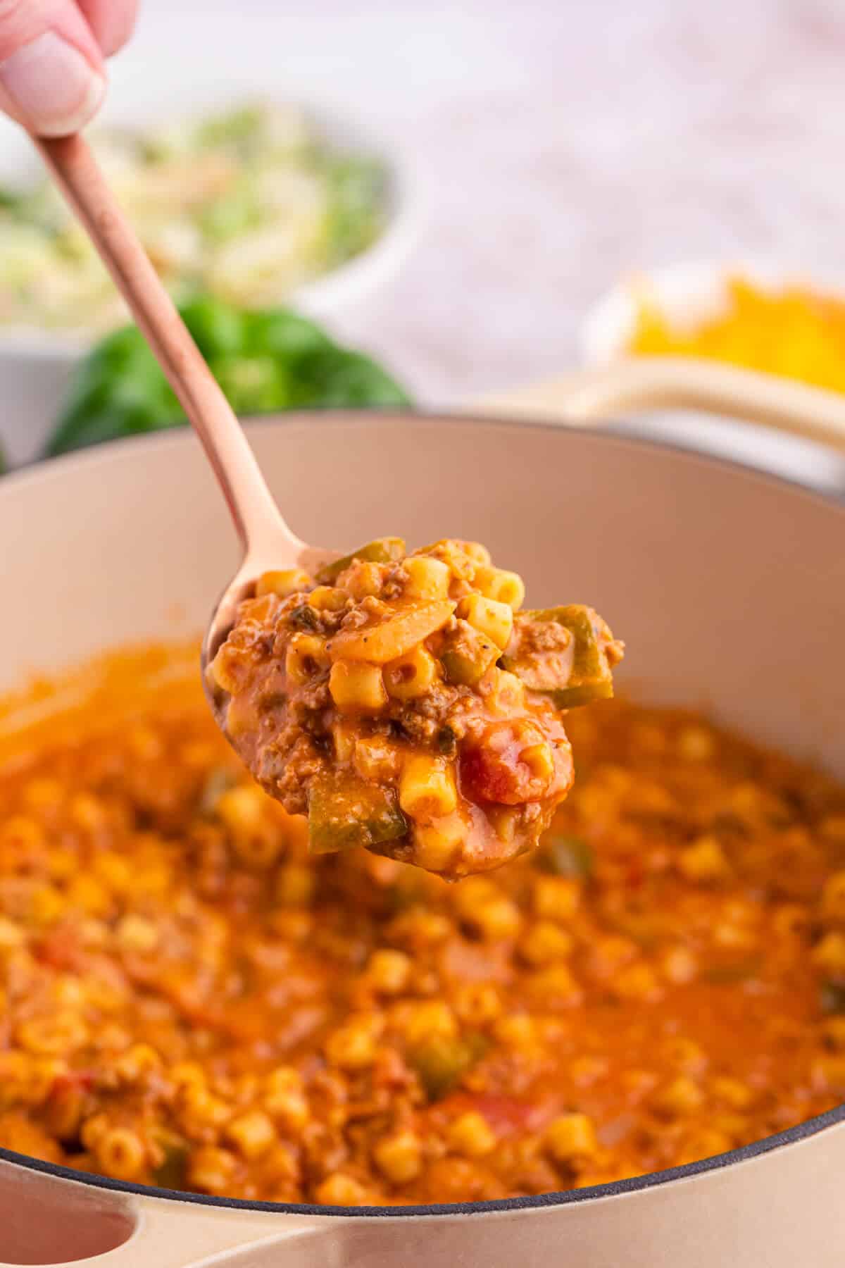 A serving spoon with unstuffed pepper pasta.