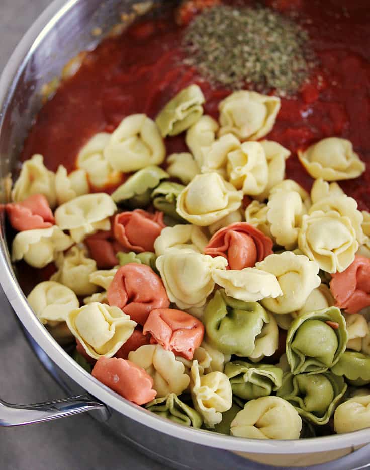 One-Pot Sausage & Cheese Cappelletti - dinner is served in less than 30 minutes with this simple #OnePotPasta recipe! Made with fresh pasta, tomato sauce, hot Italian sausage, cheese and more.