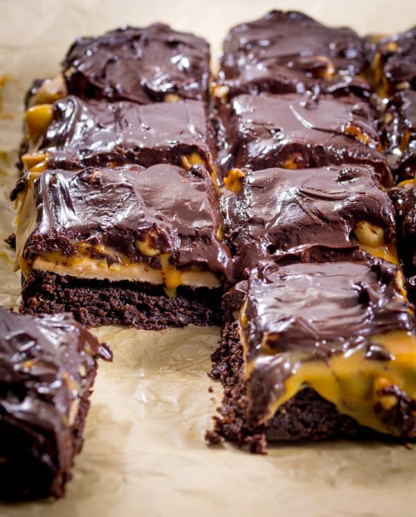 Snickers Brownies - Delicious AND gluten free! This decadent dessert recipe is a chocolate lover's dream with layers of nougat, peanuts, and caramel over a rich, moist brownie.