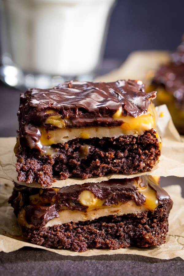 Snickers Brownies - Delicious AND gluten free! This decadent dessert recipe is a chocolate lover's dream with layers of nougat, peanuts, and caramel over a rich, moist brownie.