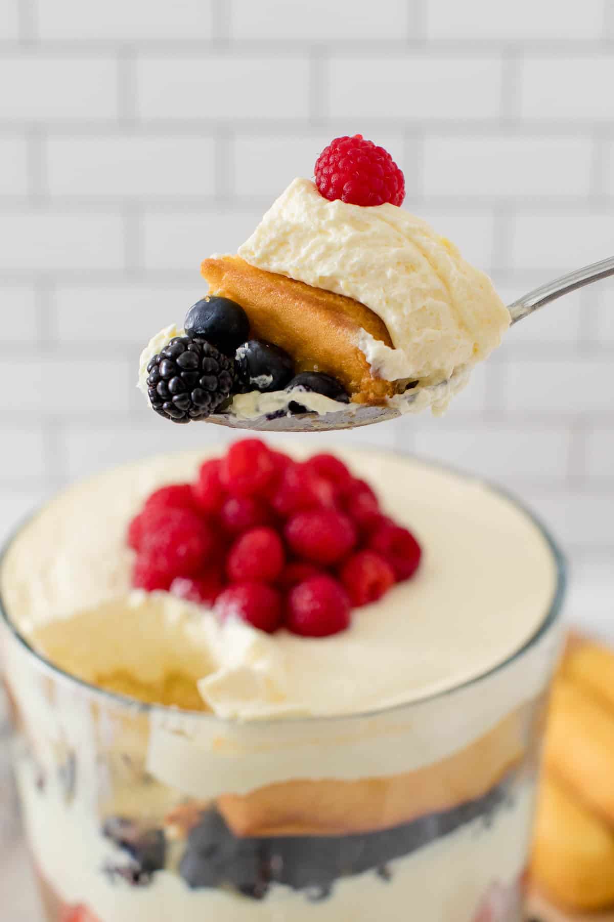 Berry cheesecake trifle on a serving spoon.