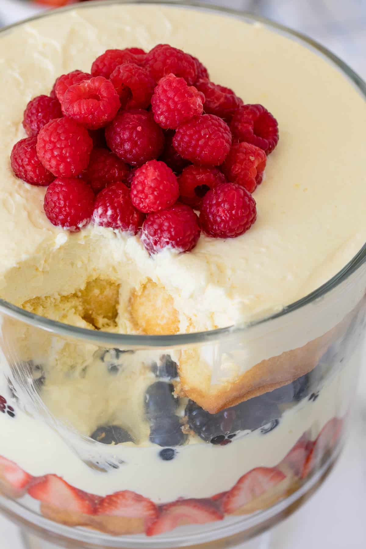 Berry cheesecake trifle with a scoop removed.