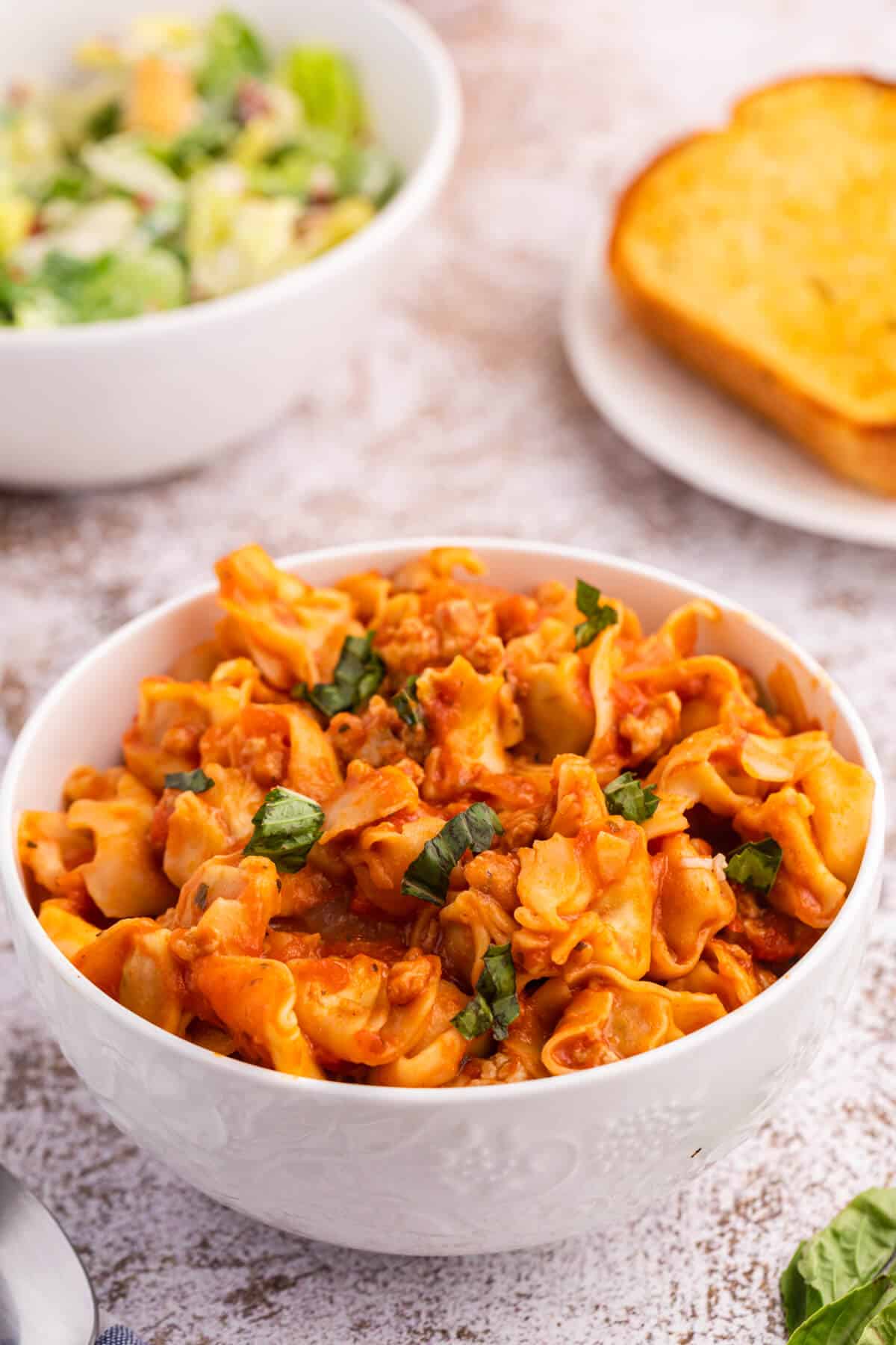 A bowl of sausage and cheese cappelletti.