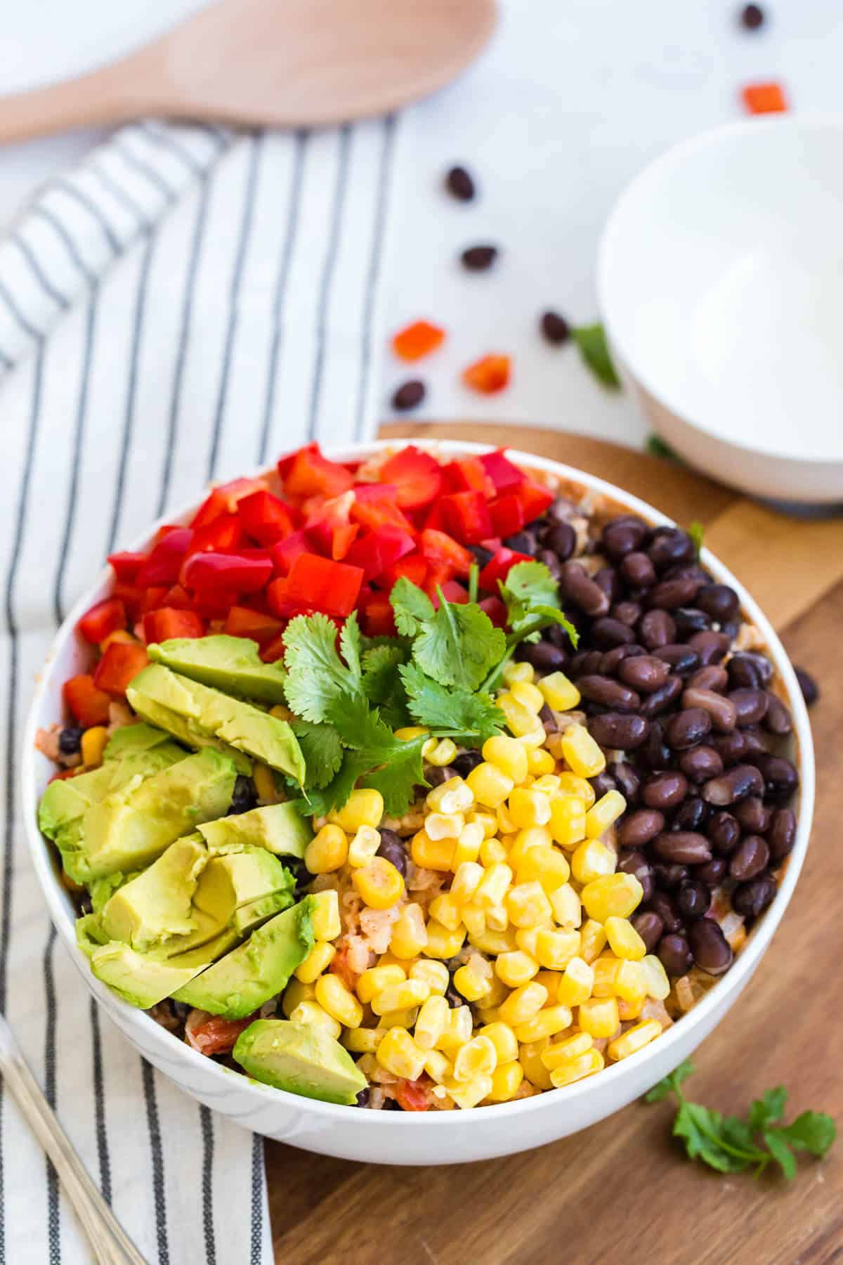 Cauliflower rice enchilada bowl with all the toppings in the bowl.