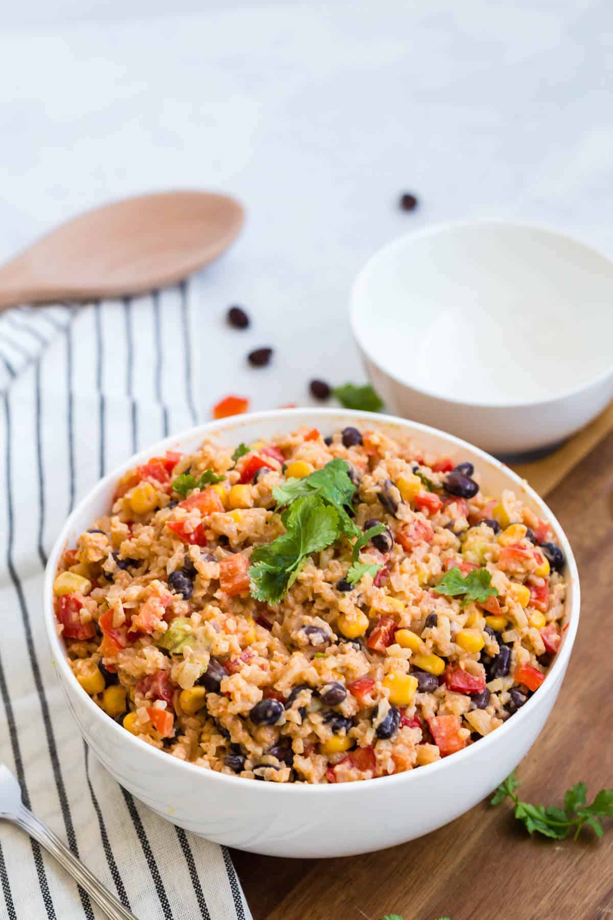 Cauliflower rice enchilada bowl topped with fresh cilantro.