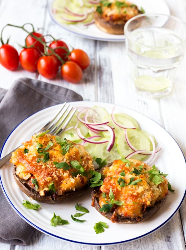 A plate of cheese and butterbean stuffed mushrooms and red onion salad.