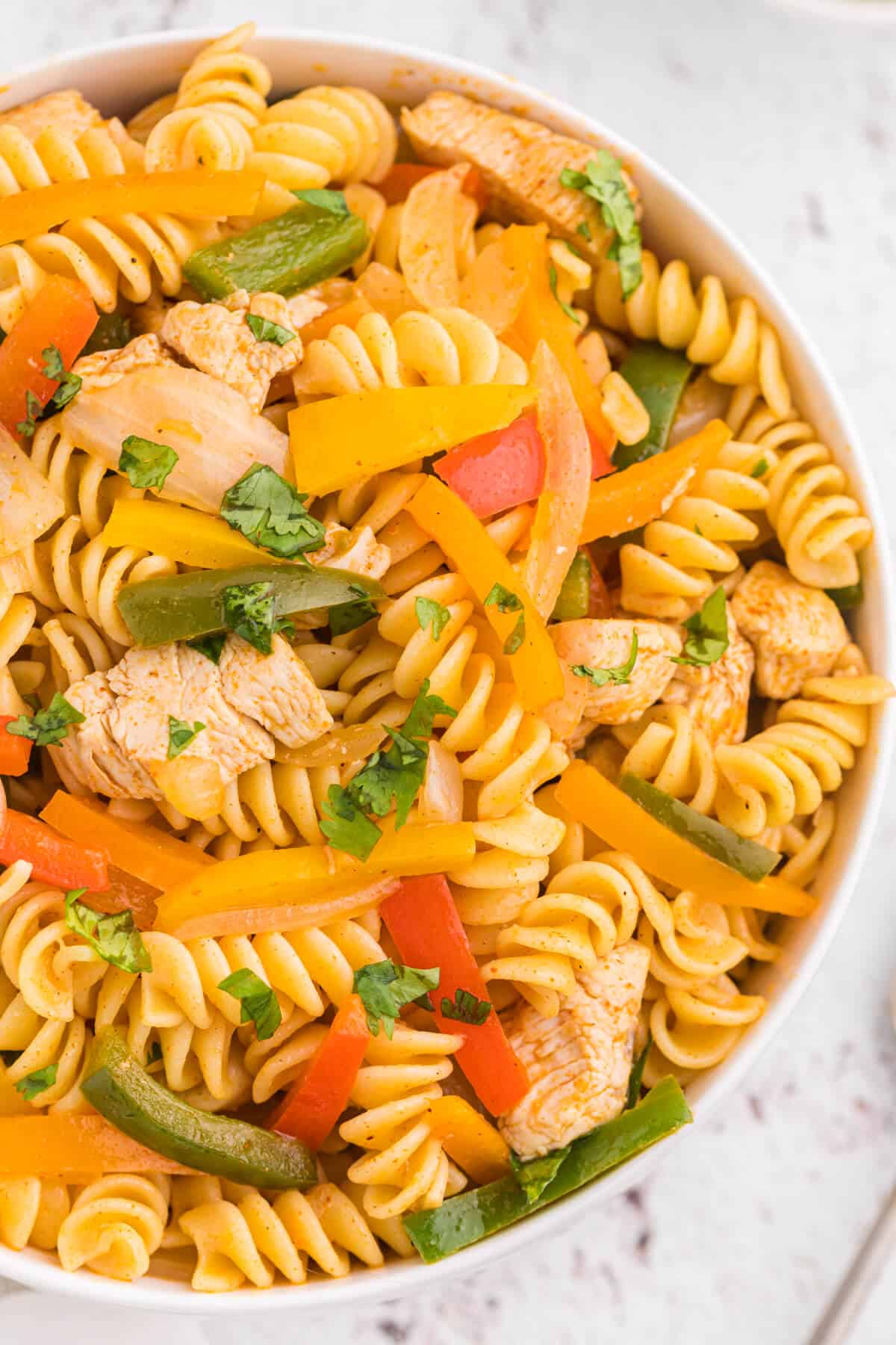 Chicken fajita pasta salad in a white bowl.