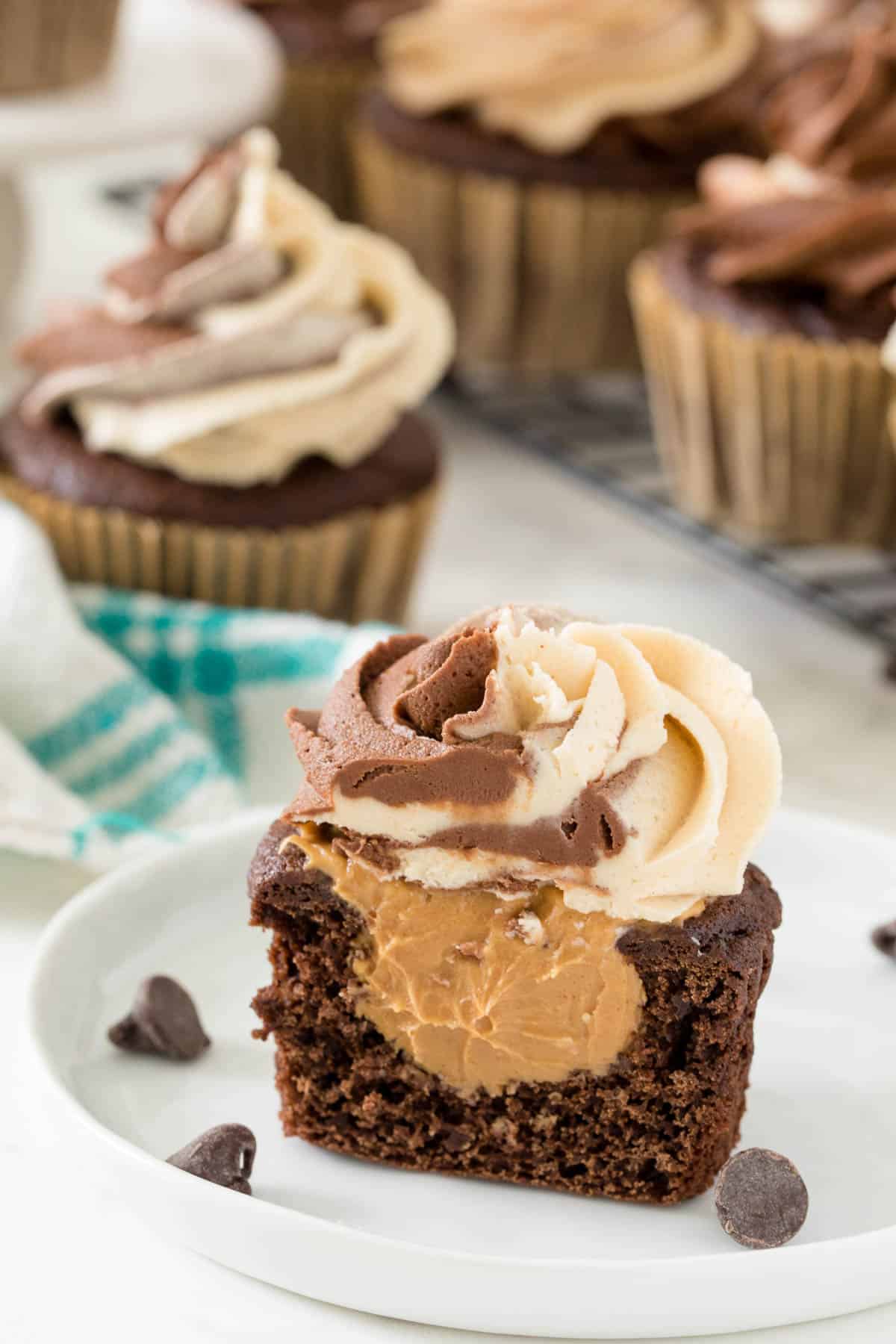 a sliced chocolate peanut butter cupcake on a plate