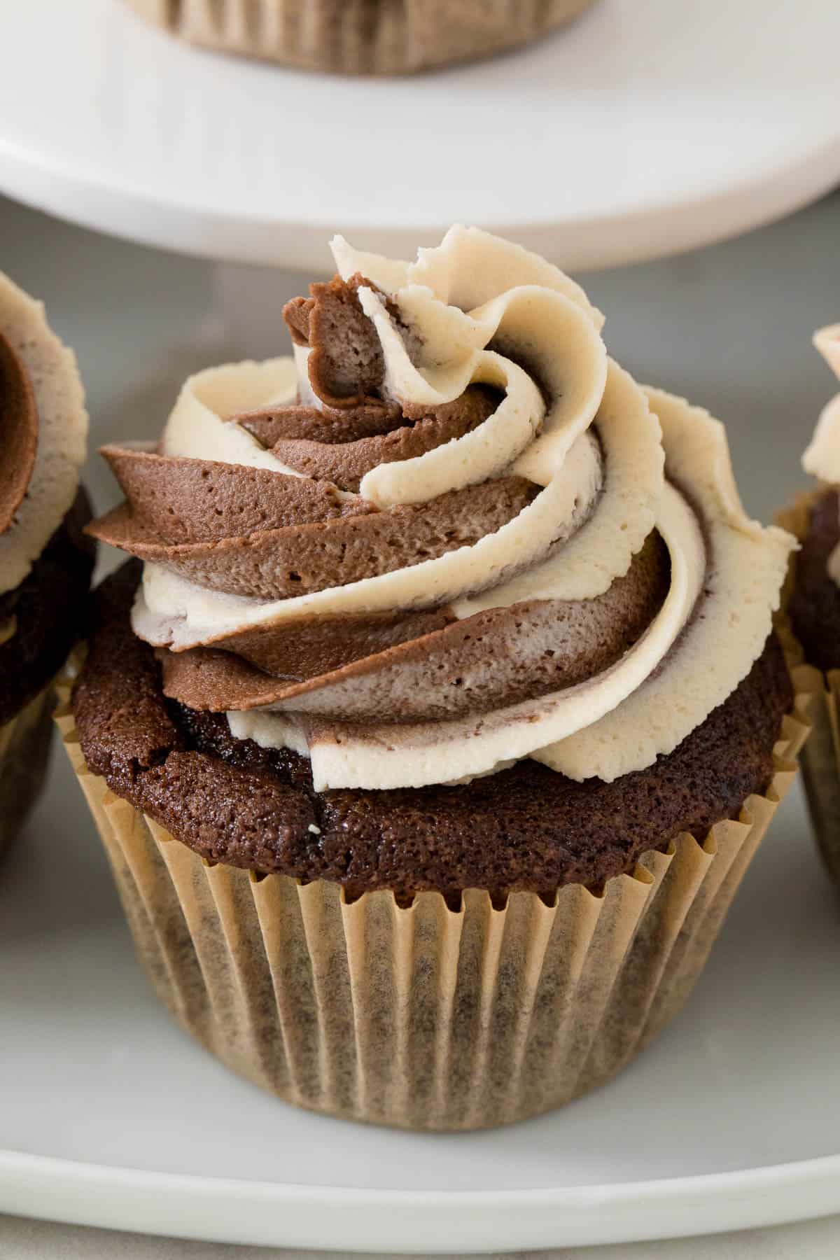 A chocolate peanut butter cupcake on a stand