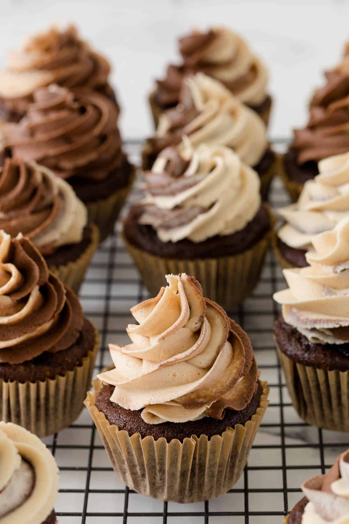 chocolate peanut butter cupcakes on a wire cooling rack