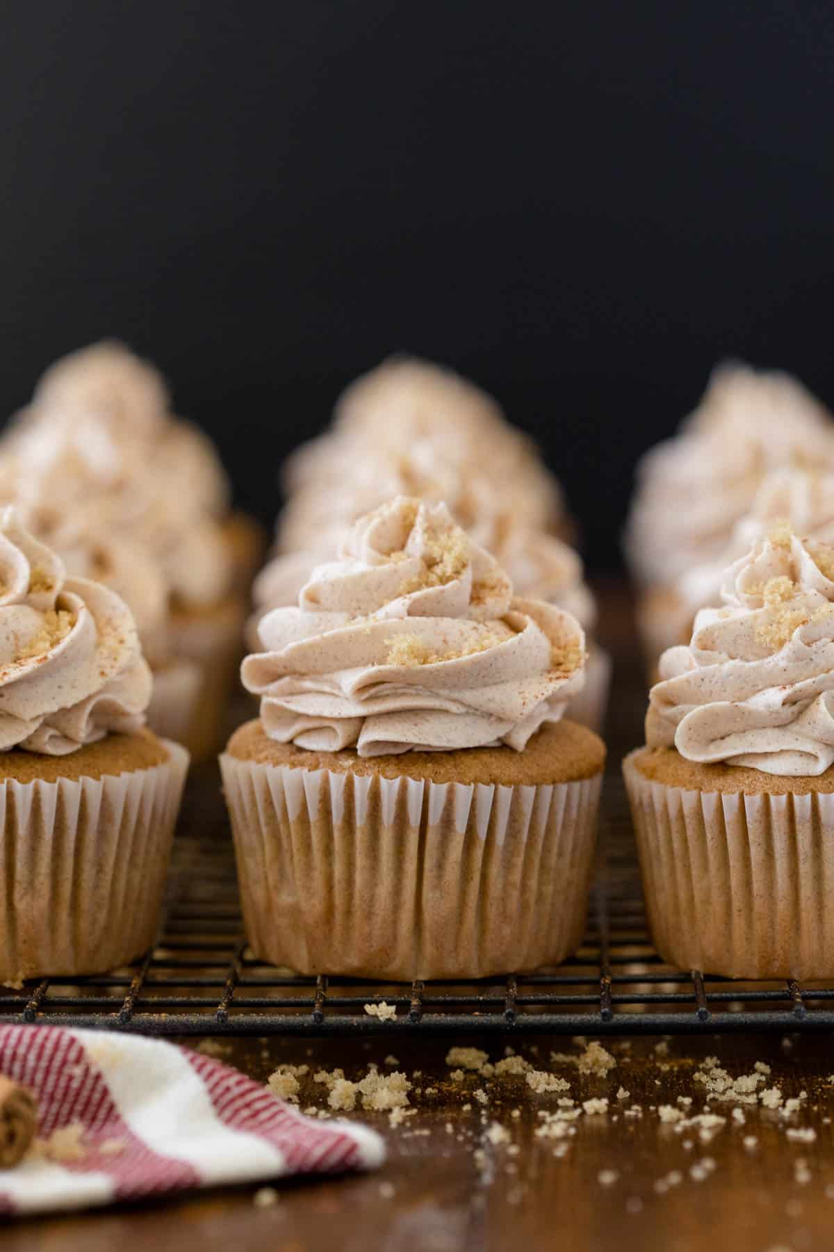 Snickerdoodle cupcakes on a wire rack.