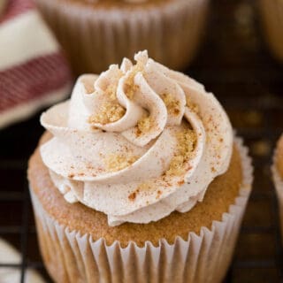 A cupcake on a wire rack.