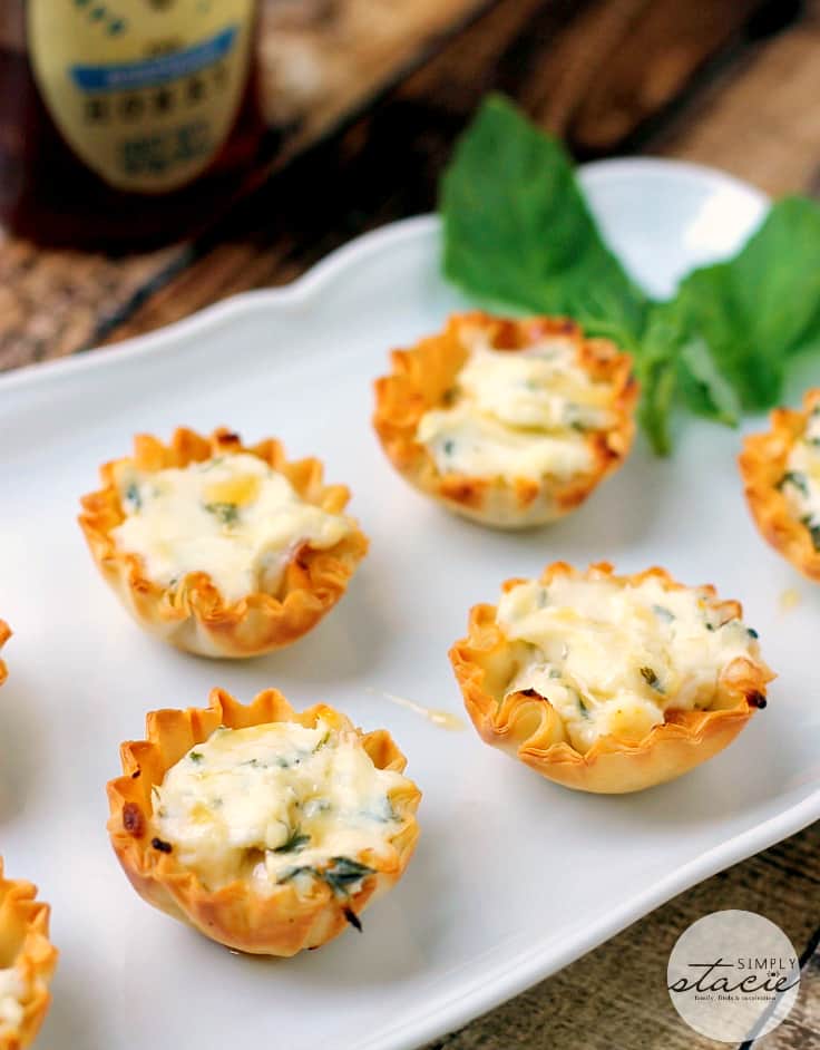 Spring Herb Tartlets with Honey and Goat Cheese - A goat cheese tartlet with a drizzle of honey topped with fresh herbs for an incredible flavor!