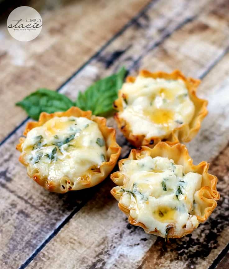 Spring Herb Tartlets with Honey and Goat Cheese - A goat cheese tartlet with a drizzle of honey topped with fresh herbs for an incredible flavor!