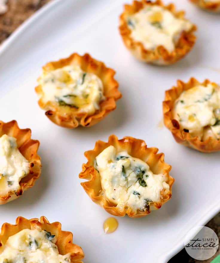 Spring Herb Tartlets with Honey and Goat Cheese - A goat cheese tartlet with a drizzle of honey topped with fresh herbs for an incredible flavor!