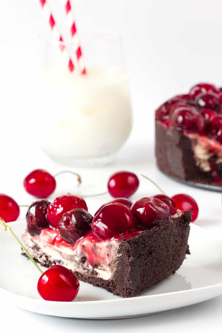 Cherry Cheesecake with Oreo Crust - Chocolate and cherry combine for this decadent dessert! The sweet cheesecake filling melds perfectly with the crunchy cookie crust for a delicious and beautiful treat.