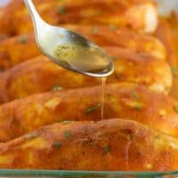Marinade being drizzled on chicken.