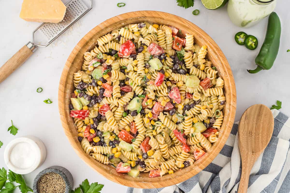 A wooden bowl filled with jalapeno ranch pasta salad.