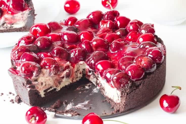 Cherry Cheesecake with Oreo Crust - Chocolate and cherry combine for this decadent dessert! The sweet cheesecake filling melds perfectly with the crunchy cookie crust for a delicious and beautiful treat.