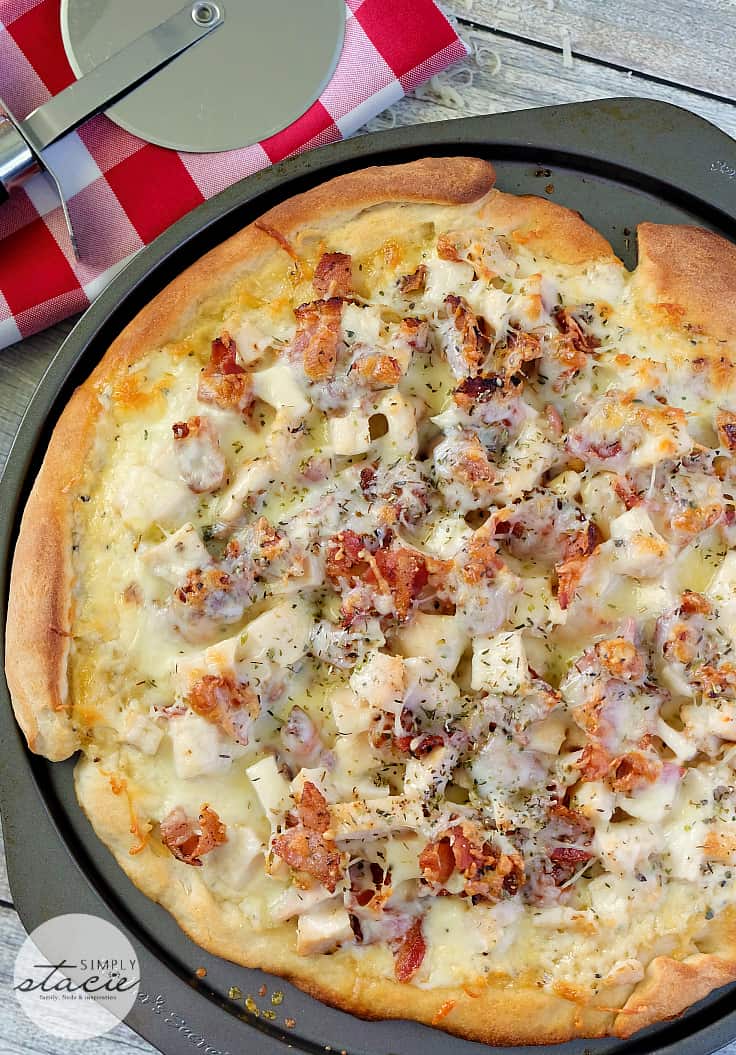 Chicken Caesar Pizza - Your favorite salad can also be your favorite homemade pizza recipe! Ditch the lettuce and make this simple crowdpleaser. Imagine pizza crust smothered in creamy Caesar dressing, topped with bacon, chicken and cheese!