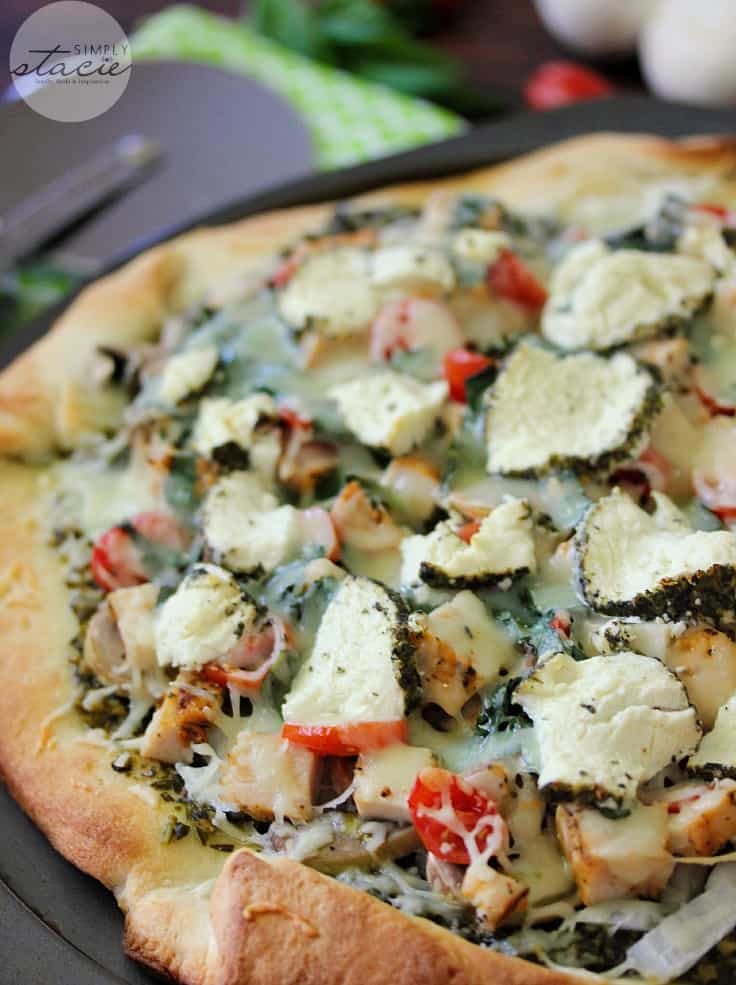 Chicken Pesto Pizza - Skip the frozen aisle and try this pizza recipe! Made with a simple pesto, tender chicken chunks, mushrooms, tomatoes and cheese.