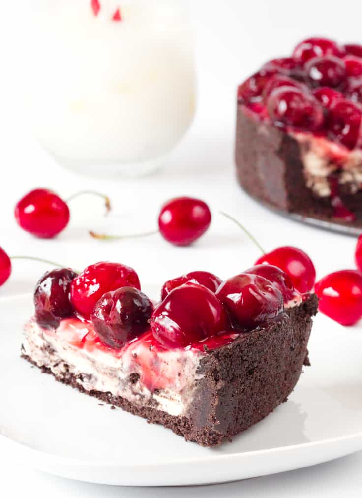 Cherry Cheesecake with Oreo Crust - Chocolate and cherry combine for this decadent dessert! The sweet cheesecake filling melds perfectly with the crunchy cookie crust for a delicious and beautiful treat.