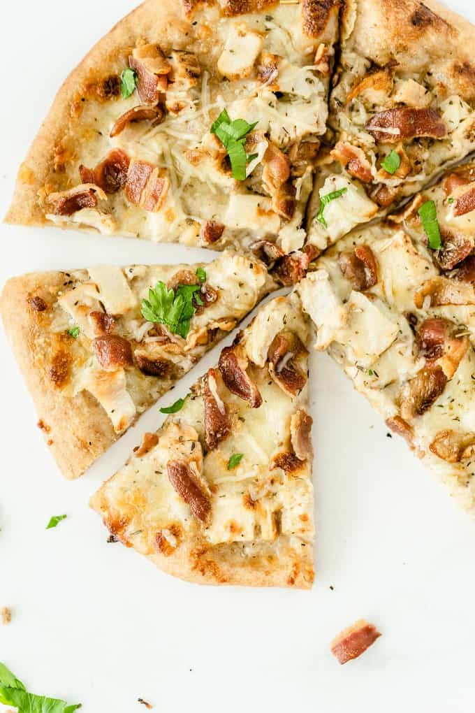 Chicken Caesar Pizza - Your favorite salad can also be your favorite homemade pizza recipe! Ditch the lettuce and make this simple crowdpleaser. Imagine pizza crust smothered in creamy Caesar dressing, topped with bacon, chicken and cheese!