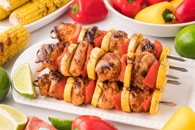 Chipotle chicken skewers on a platter.