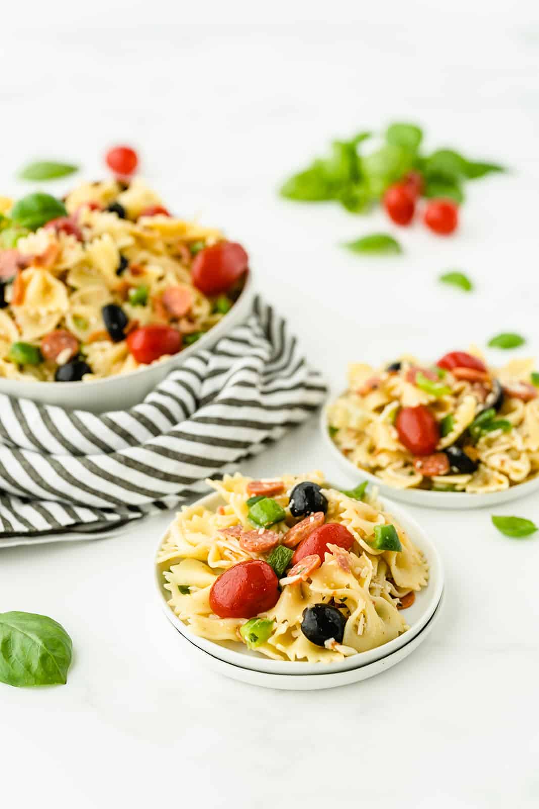 Pizza Pasta Salad - A perfect summer dish with all the best pizza flavors! Salty pepperoni and olives are coated in tangy Italian dressing and covered in cheese.