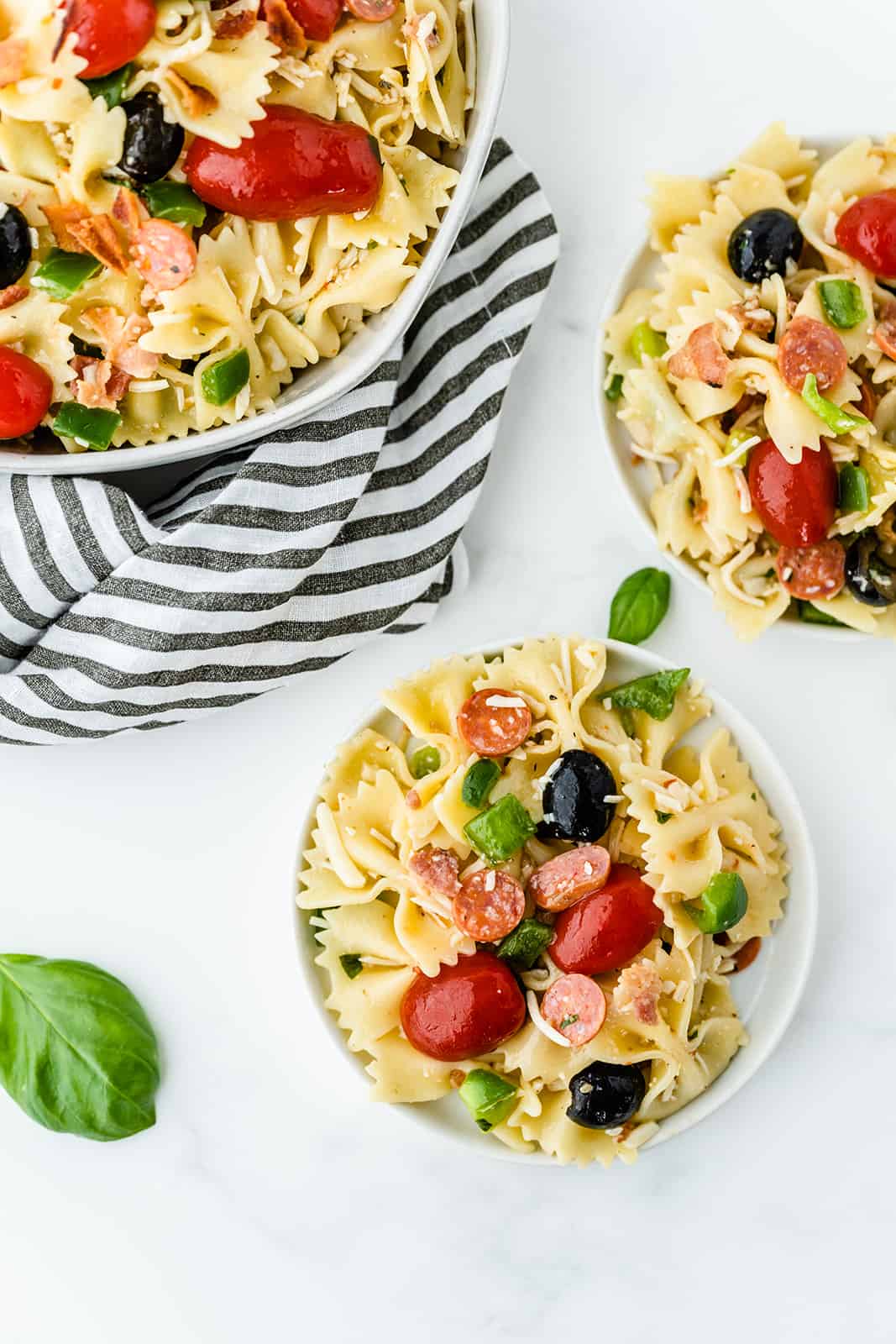 Pizza Pasta Salad - A perfect summer dish with all the best pizza flavors! Salty pepperoni and olives are coated in tangy Italian dressing and covered in cheese.