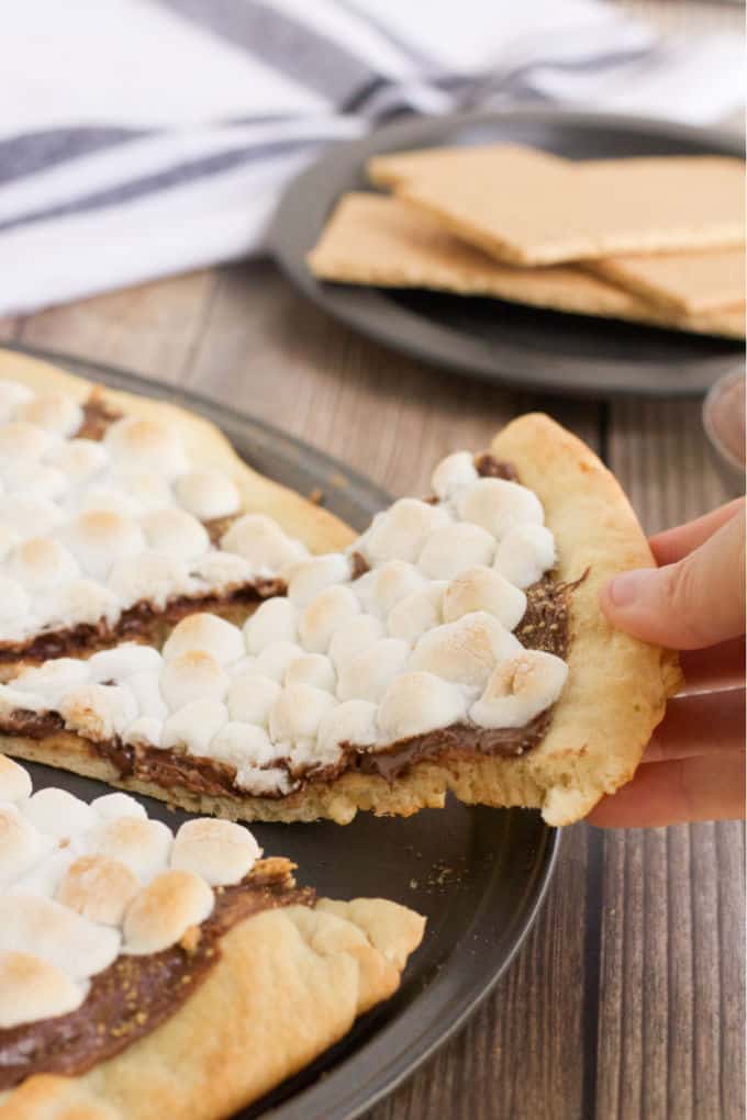 S'mores Pizza - S'mores indoors! Bring the camping to the oven with this graham cracker, chocolate, and marshmallow pizza for a great family night treat.
