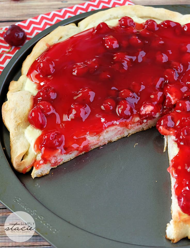 Cherry Cheesecake Pizza - NYC's favorites combined for the best dessert pizza! Smooth cheesecake filling covered with cherries in a thick, sweet syrup is a perfect handheld dessert for your next party.