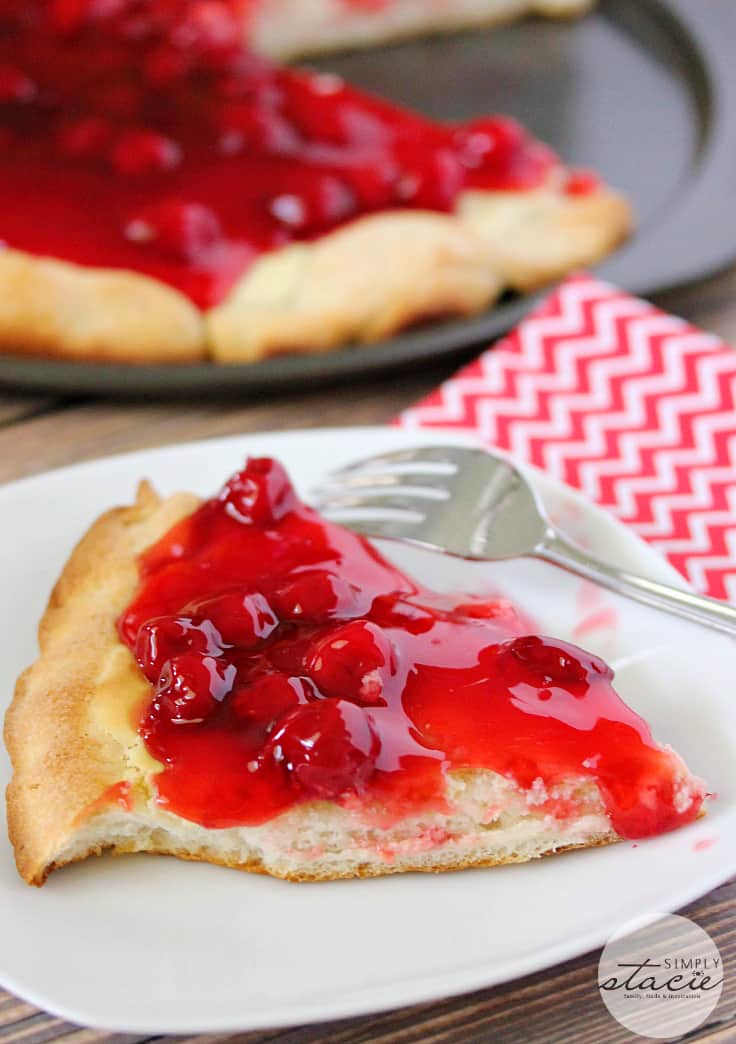 Cherry Cheesecake Pizza - NYC's favorites combined for the best dessert pizza! Smooth cheesecake filling covered with cherries in a thick, sweet syrup is a perfect handheld dessert for your next party.