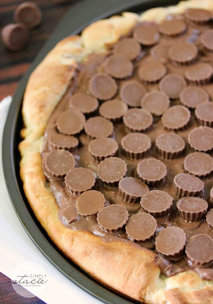 Reese Peanut Butter Pizza - Reese's lovers, rejoice! This dessert pizza is covered with a chocolatey peanut butter spread and topped with mini Reese's cups for a double dose of the sweet treat.