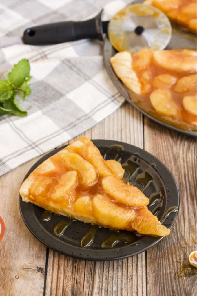 Caramel Apple Pizza - The PERFECT fall dessert pizza! Sweet cinnamon apple pie filling with rich caramel covering a basic pizza crust for the taste of pie without the mess and wait.