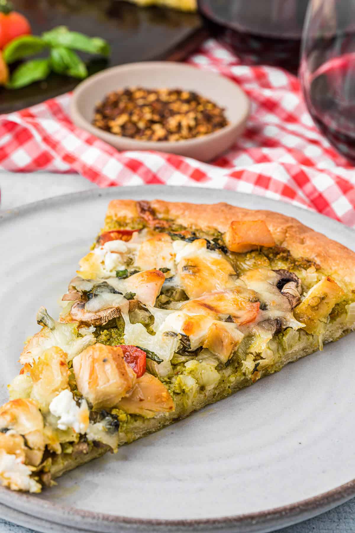A slice of pizza on a white plate.