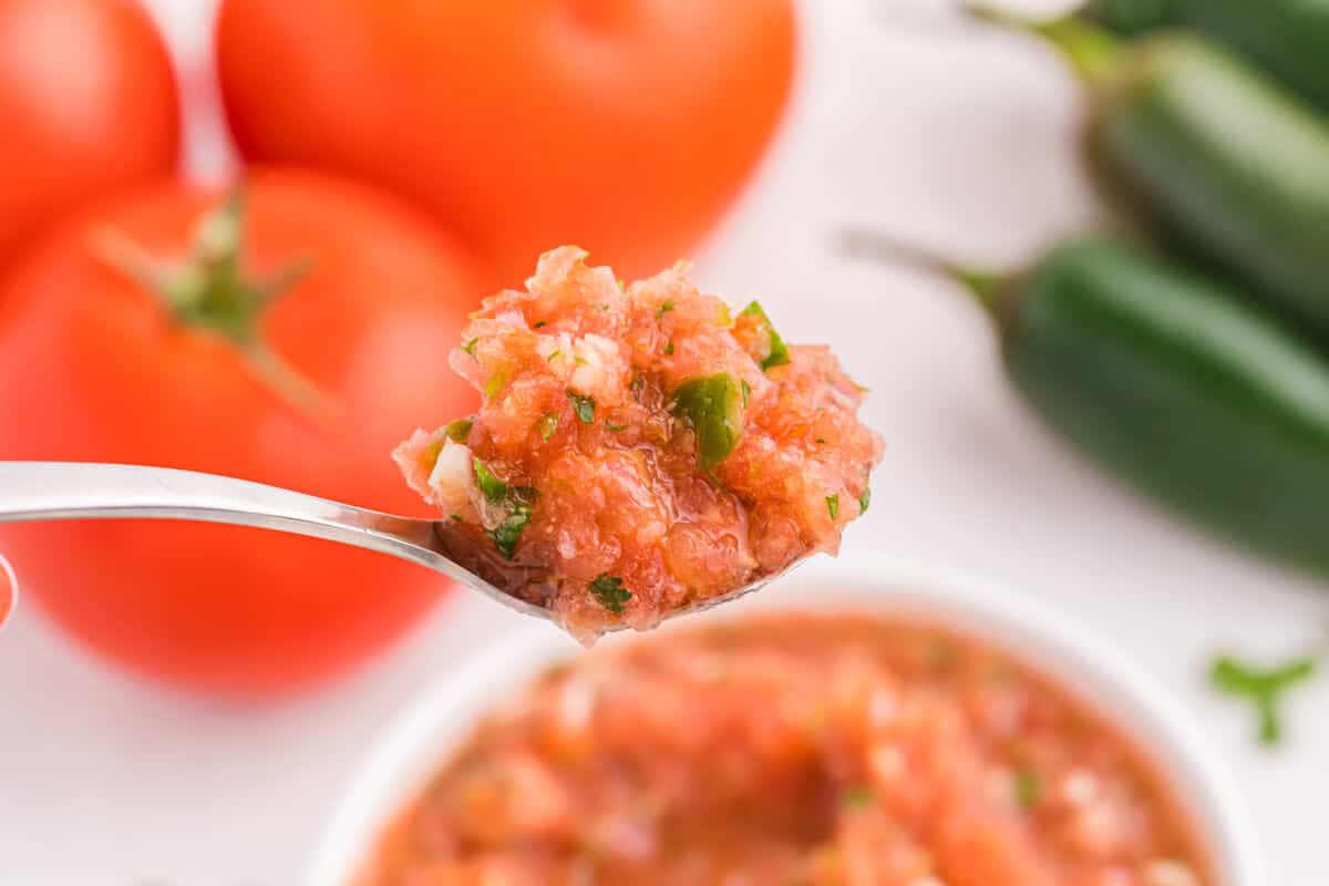 Garden salsa on a spoon.