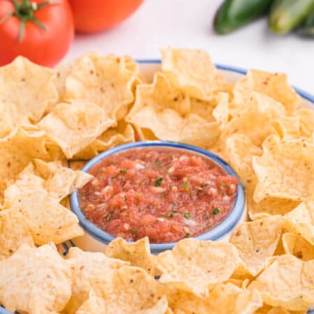 Garden salsa on a serving platter with tortilla chips.