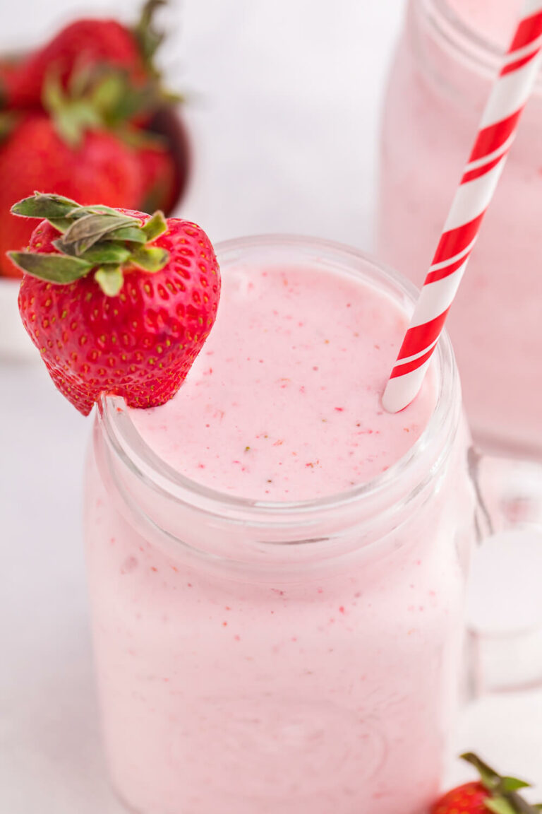 The recipe in a mug with a straw and a strawberry for garnish.