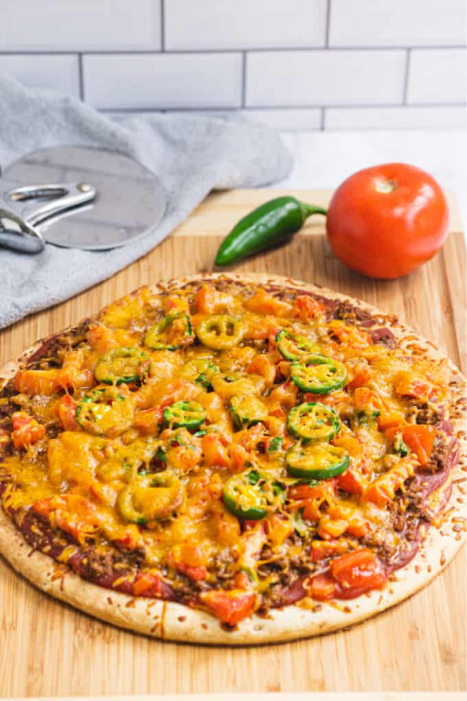 Taco Pizza - Bring Mexican night to your pizzas! Loaded with ground beef, cheese, and tons of veggies, you won't even miss the tortillas.