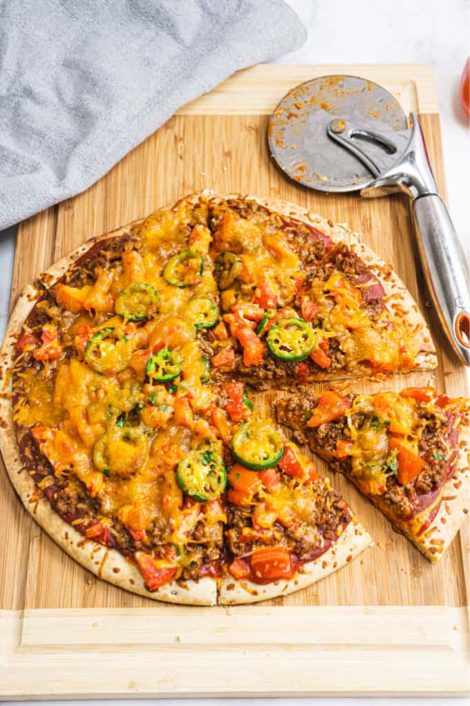 Taco Pizza - Bring Mexican night to your pizzas! Loaded with ground beef, cheese, and tons of veggies, you won't even miss the tortillas.