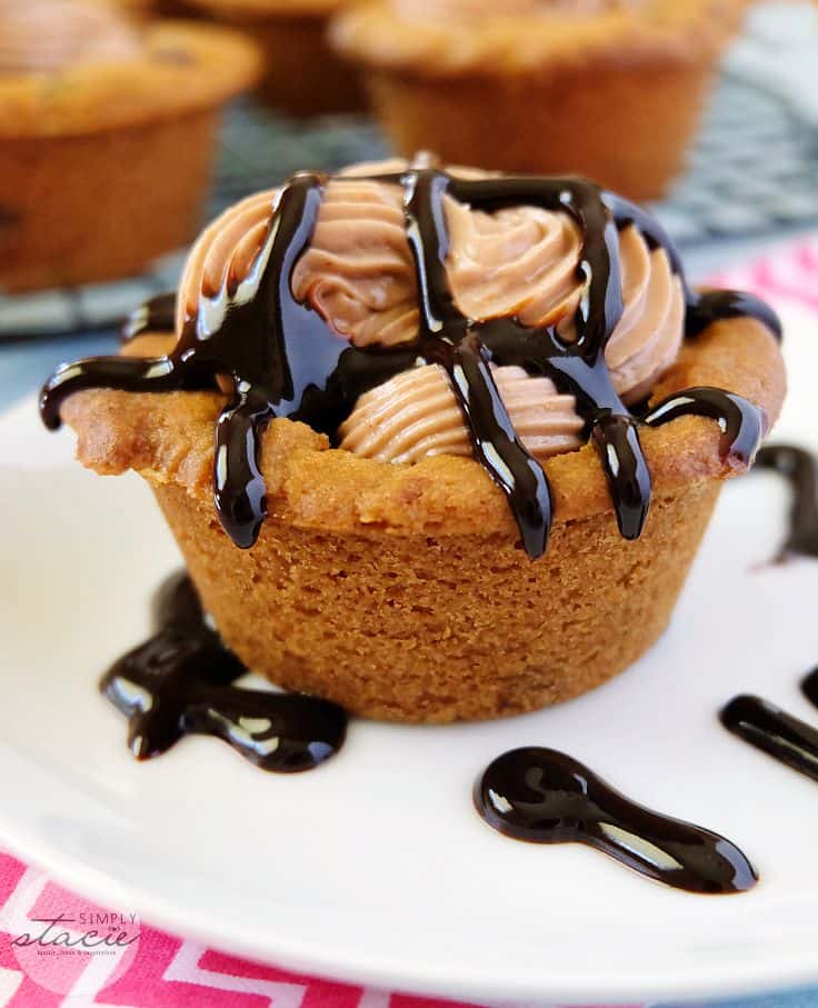 Reese's Peanut Butter Cookie Cups - Peanut butter cups in cookie cups for this peanut butter lover's dessert! Topped with cream cheese frosting!