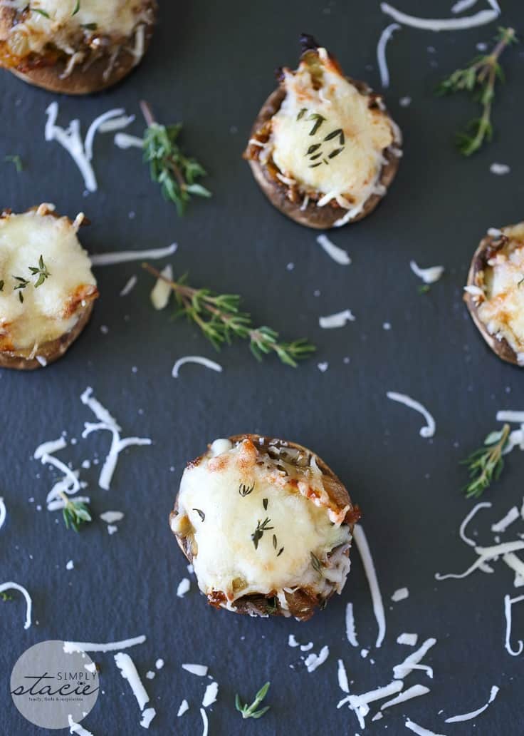 French Onion Stuffed Mushrooms - This perfect party appetizer is stuffed with sweet onions sautéed in beef broth and fresh herbs. Topped with melted mozzarella cheese, you'll never look at stuffed mushrooms the same again!