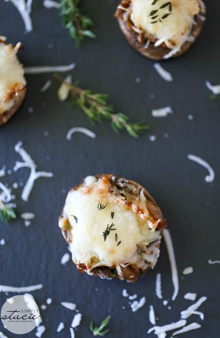 French Onion Stuffed Mushrooms - This perfect party appetizer is stuffed with sweet onions sautéed in beef broth and fresh herbs. Topped with melted mozzarella cheese, you'll never look at stuffed mushrooms the same again!