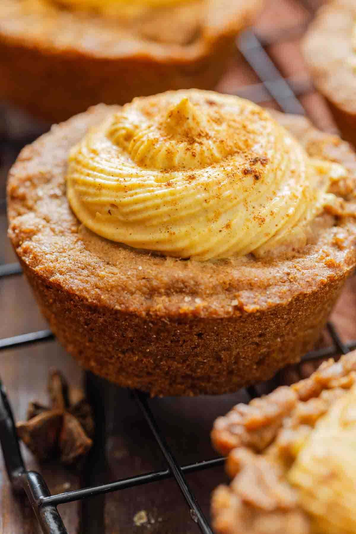 Pumpkin spice cake cup on a wire rack.