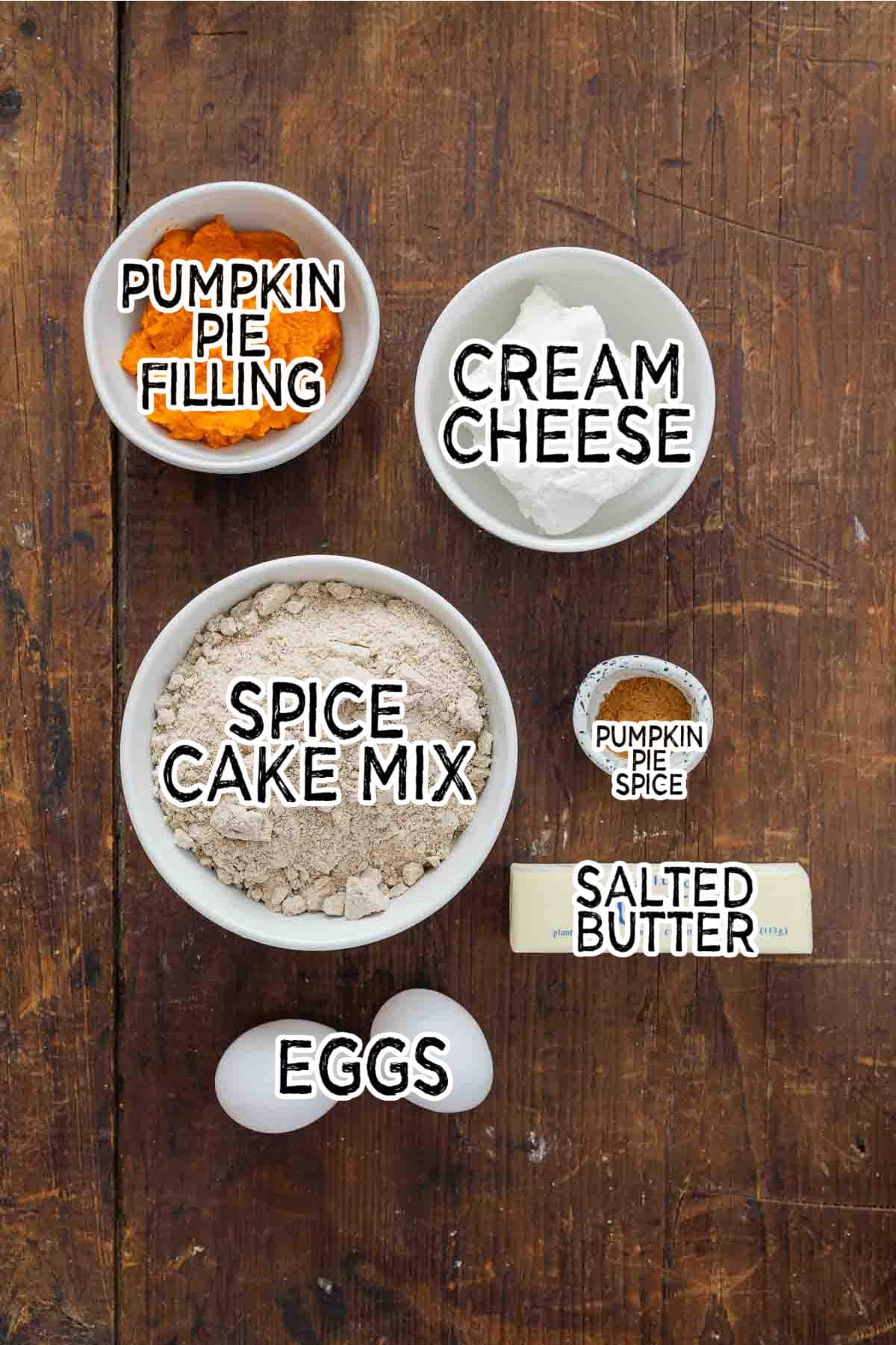 Ingredients in white bowls on a wooden surface.