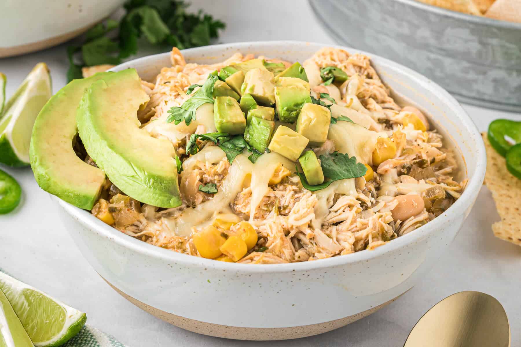 Slow cooker verde chicken chili in a white bowl.